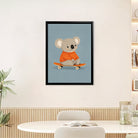 Framed Art Print of a Cute Koala in an Orange Sweater Riding a Skateboard, Perfect for Nursery or Home Decor